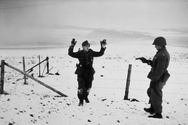 BELGIUM.-Near-Bastogne.-December-23rd-26th,-1944.-A-US-soldier-with-a-German-prisoner-of-war-during-the-Battle-of-the-Bulge.