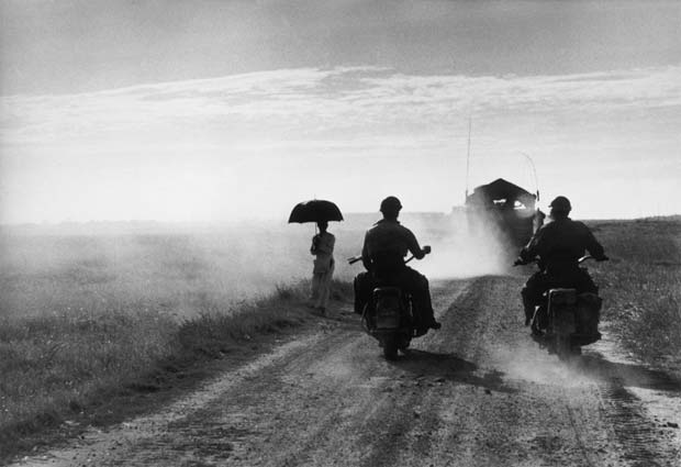 NDOCHINA-(VIETNAM).-May,-1954.-Motorcyclists-and-woman-walking-on-the-road-from-Nam-Dinh-to-Thai-Binh.